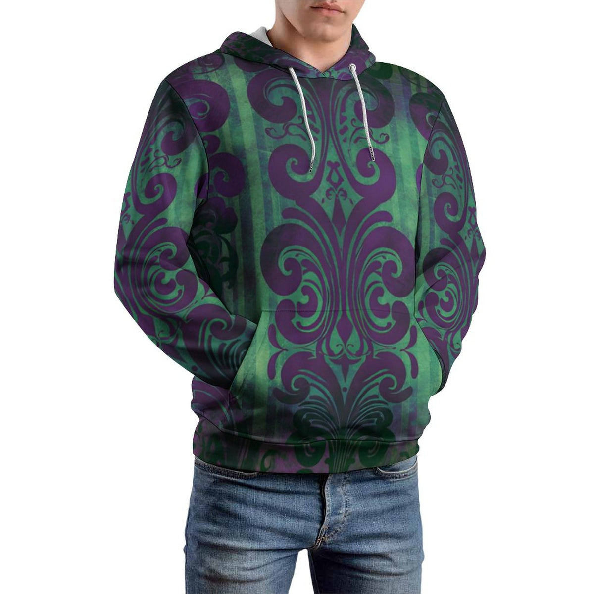 A man wearing a green and purple damask-patterned hoodie with white drawstrings, paired with blue jeans, shown against a plain white background.