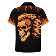 A black short-sleeve camp collar shirt shown from the back, featuring a large fiery orange and yellow skull graphic with flames, and flame motifs along the shoulders and sleeves, on a plain white background.